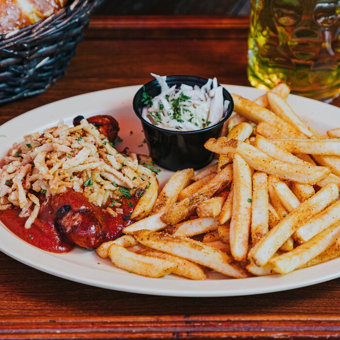 Bratwurst plate with pretzels, fries and beer at Bratz Y'all