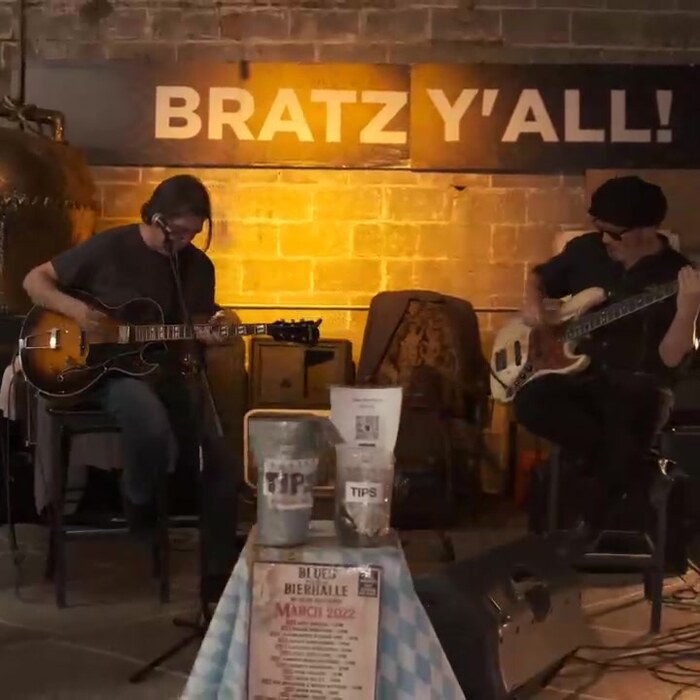 Live blues duo playing under the Bratz Y'all sign